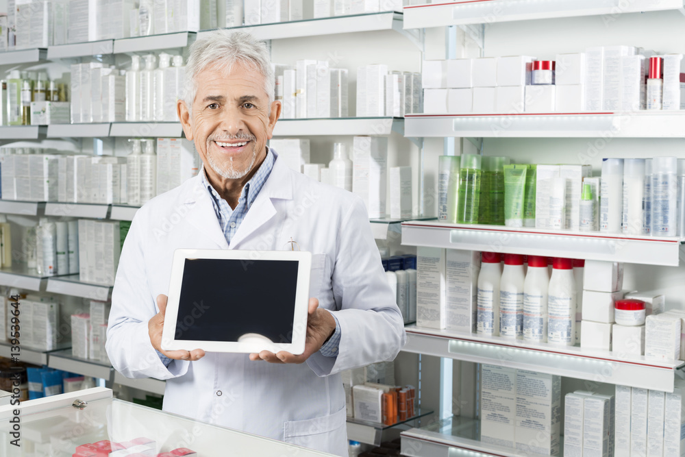 Senior Pharmacist Holding Digital Tablet With Blank Screen