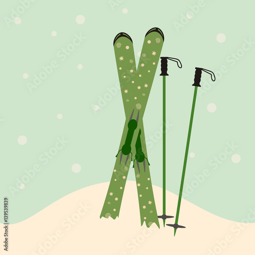 green skis and ski poles standing in snow