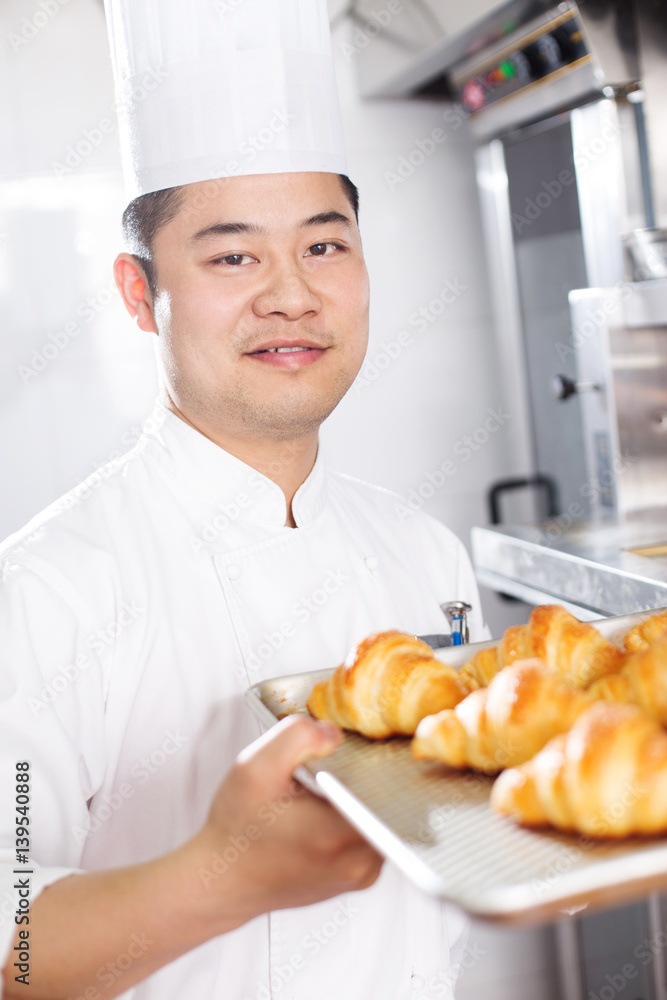 young man chelf makes bread in kitchen young man chelf makes bread in kitchen