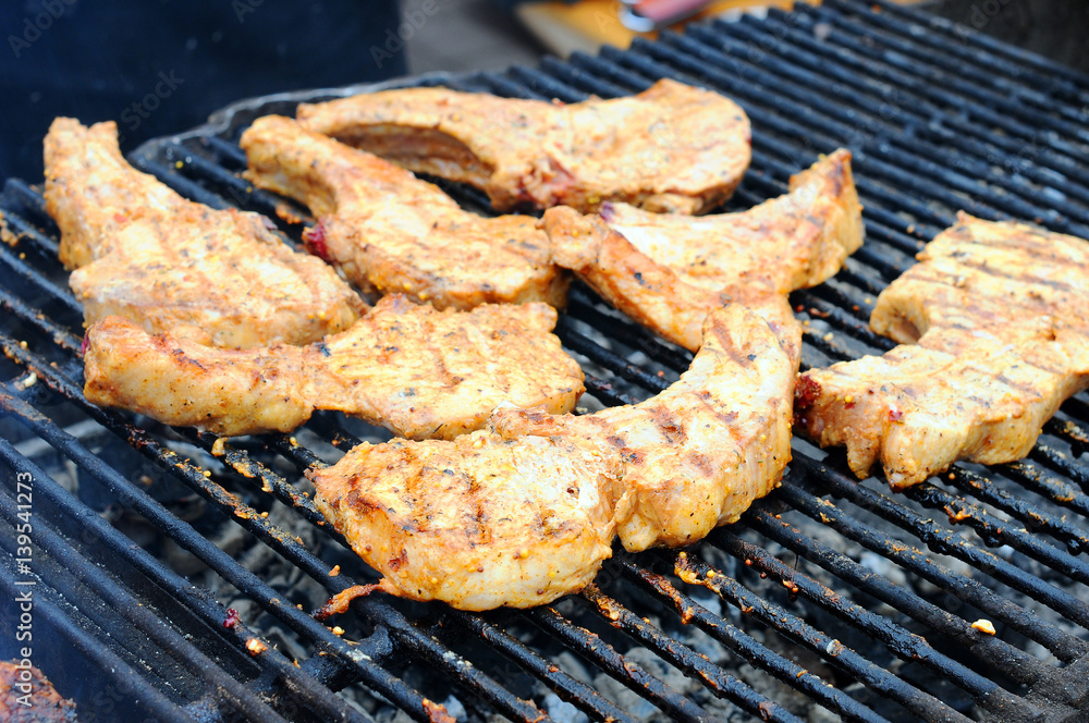 Grilling marinated shashlik on a grill. Shashlik is a form of Shish kebab popular in Eastern, Central Europe and other places. 