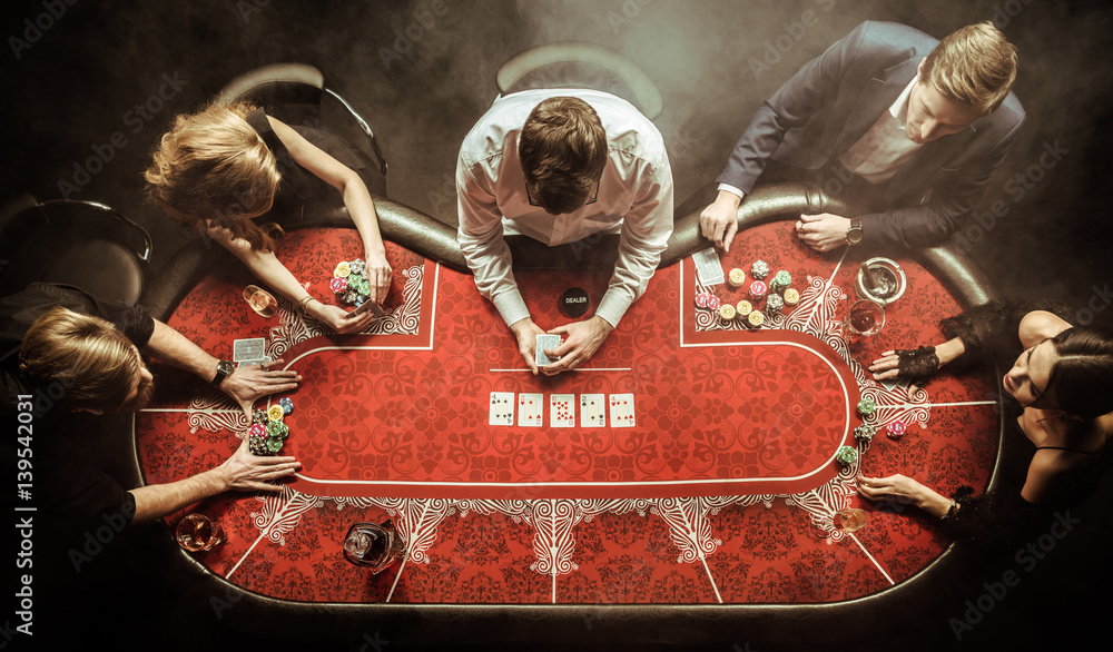 top view of men and women playing poker in casino - obrazy, fototapety, plakaty 