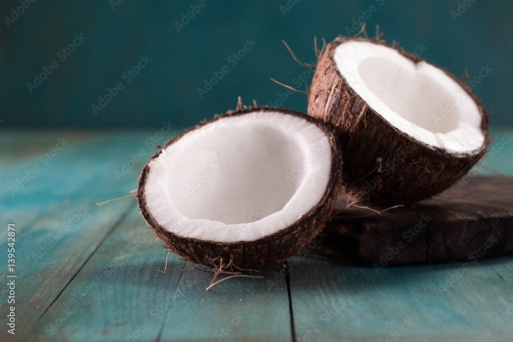 close up of a coconut on a wooden background close up of a coconut on a wooden background