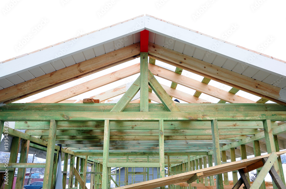 The wooden structure of the building. Wooden frame building. Wooden roof construction. The wooden structure of the building. Wooden frame building. Wooden roof construction.