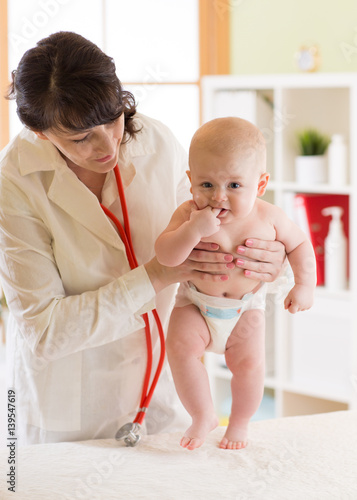 doctor examining a baby in ...