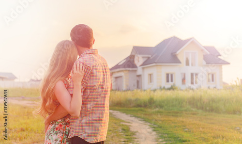 couple looking on house