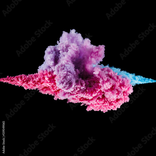 Color splashes of ink isolated on black background. Abstract paint in water motion. Swirling colorful drops