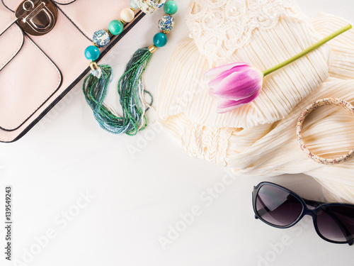 Woman clothes accessories fashion shopping. Romantic dress outfit with glasses and necklace bracelets. Summer elegant style look flat lay for blog lifestyle on white background