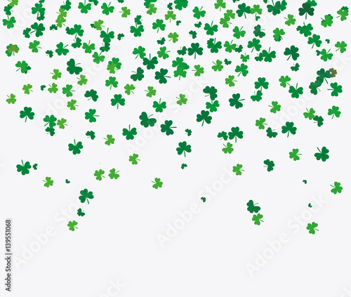 Flying leaves of clover different shades of green on a light background. Pattern for St. Patrick s Day. Rectangular  horizontal wallpaper. Vector illustration with copy space
