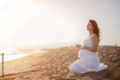 Wallpaper Mural Young pregnant woman walking on the beach  Torontodigital.ca