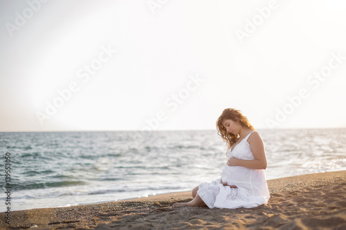 Wallpaper Mural Young pregnant woman walking on the beach  Torontodigital.ca