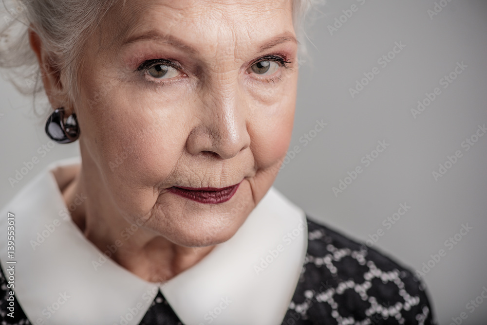 Serious elderly female looking at camera Serious elderly female looking at camera
