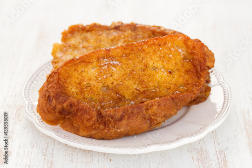 fried sweet bread with cinnamon on plate