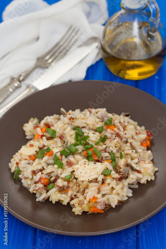 rice with chicken and vegetables on brown plate