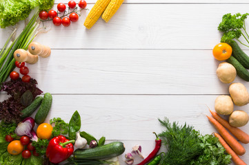 Border of fresh vegetables on white wood background with copy space