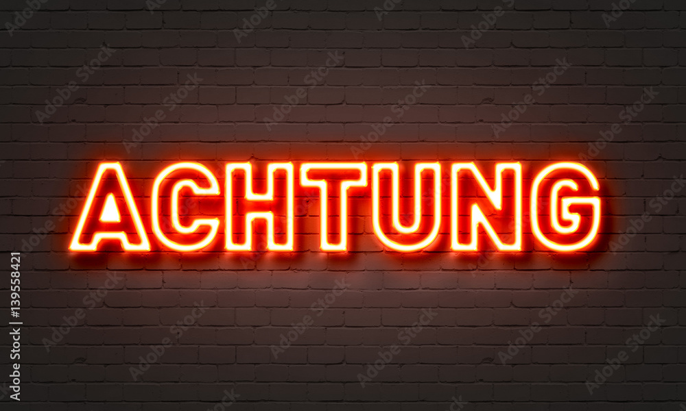 Achtung neon sign on brick wall background. Achtung neon sign on brick wall background.