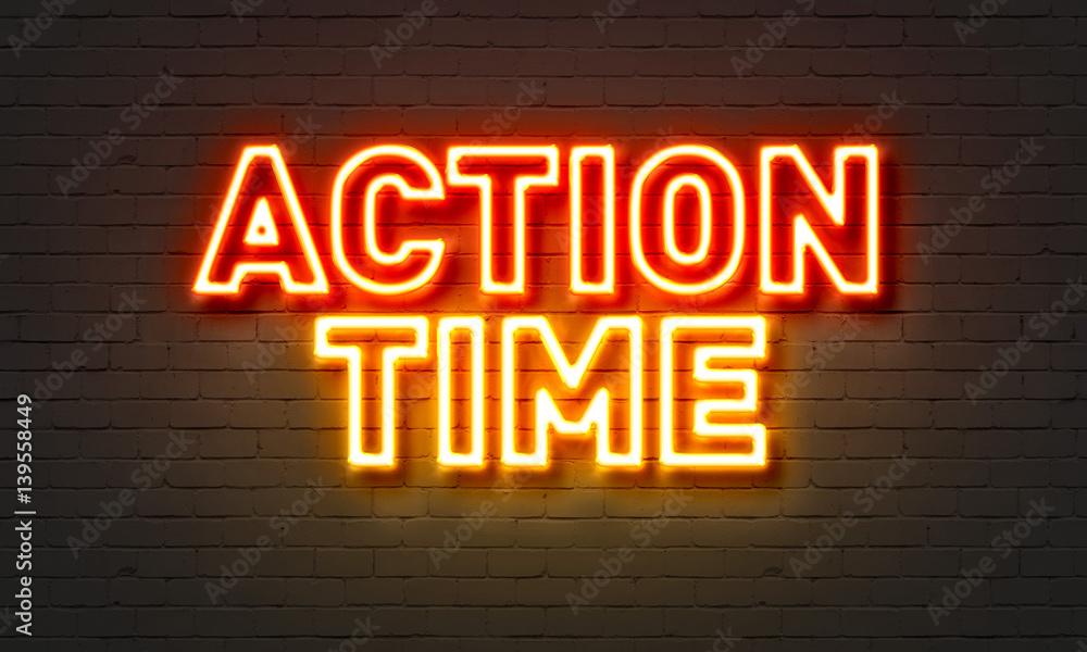Action time neon sign on brick wall background.