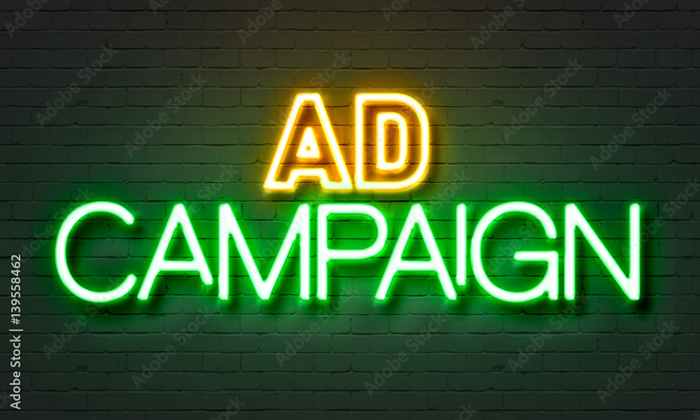 Obraz premium Ad campaign neon sign on brick wall background.