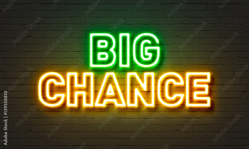 Big chance neon sign on brick wall background.