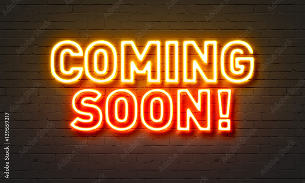 Coming soon neon sign on brick wall background. Coming soon neon sign on brick wall background.