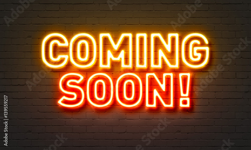 Canvastavla Coming soon neon sign on brick wall background.
