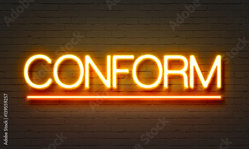 Conform neon sign on brick wall background.