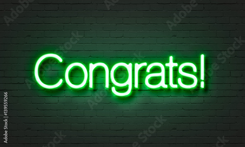 Congrats neon sign on brick wall background.