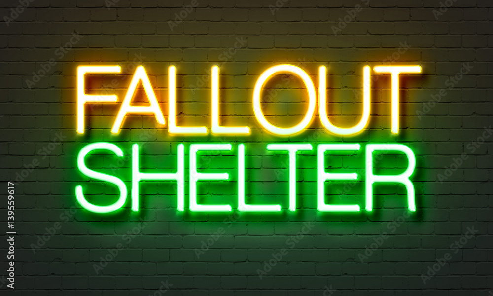 Fallout shelter neon sign on brick wall background.