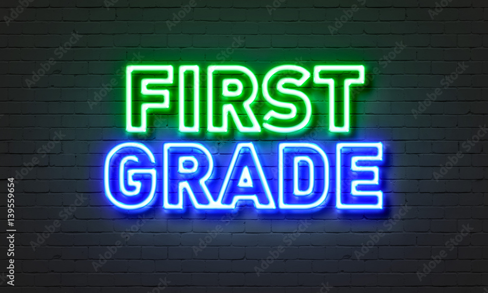 First grade neon sign on brick wall background. First grade neon sign on brick wall background.