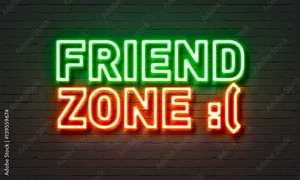 Fototapeta premium Friend zone neon sign on brick wall background.
