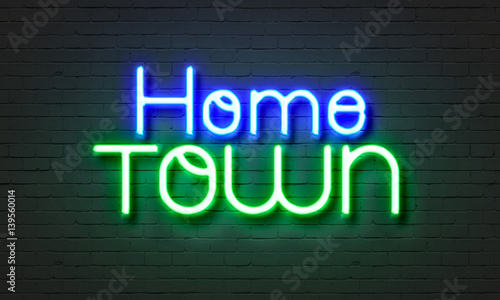 Hometown neon sign on brick wall background.