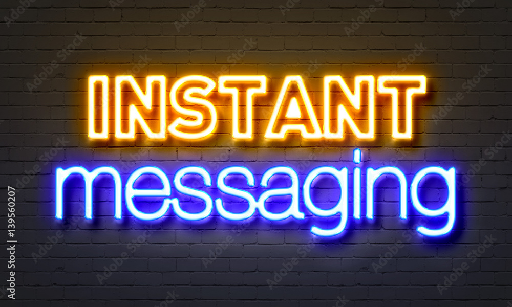 Instant messaging neon sign on brick wall background.