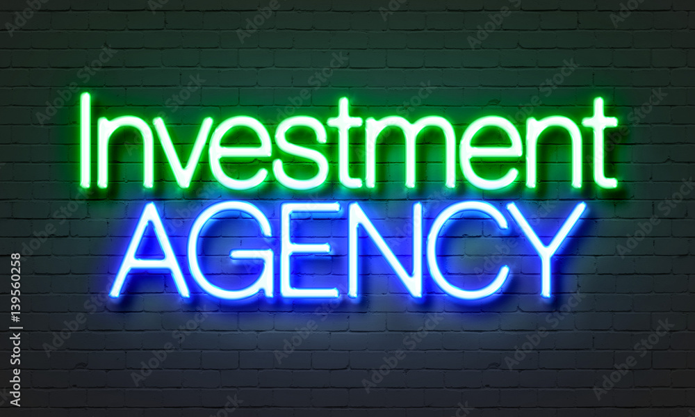 Investment agency neon sign on brick wall background.