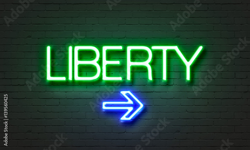 Liberty neon sign on brick wall background.