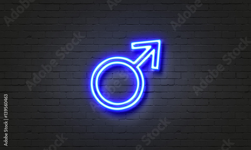 Male symbol neon sign on brick wall background.