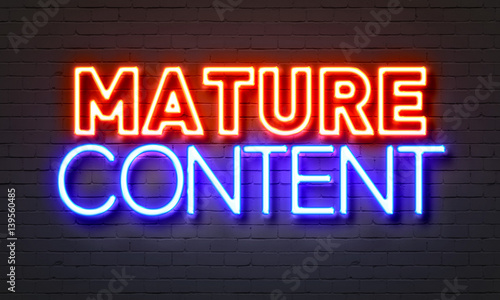 Mature content neon sign on brick wall background.