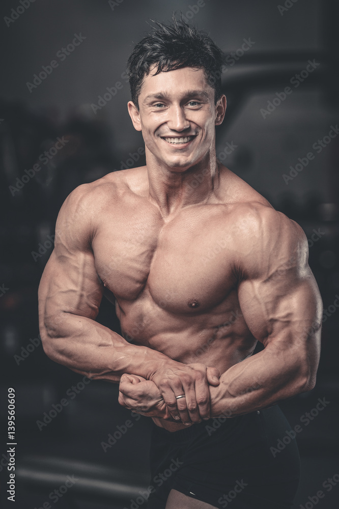 Handsome power athletic man on diet training pumping up muscles Handsome power athletic man on diet training pumping up muscles