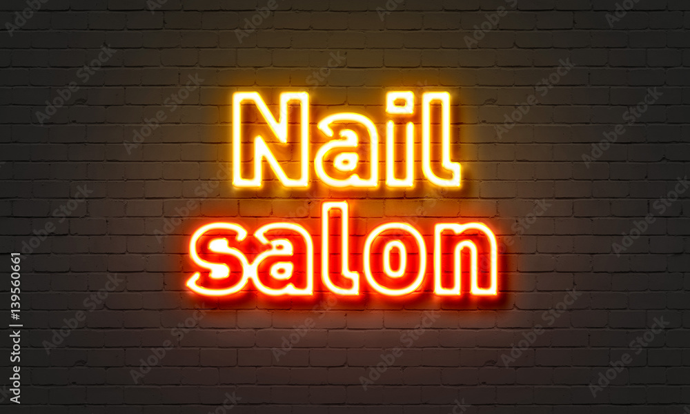 Nail salon neon sign on brick wall background. Nail salon neon sign on brick wall background.