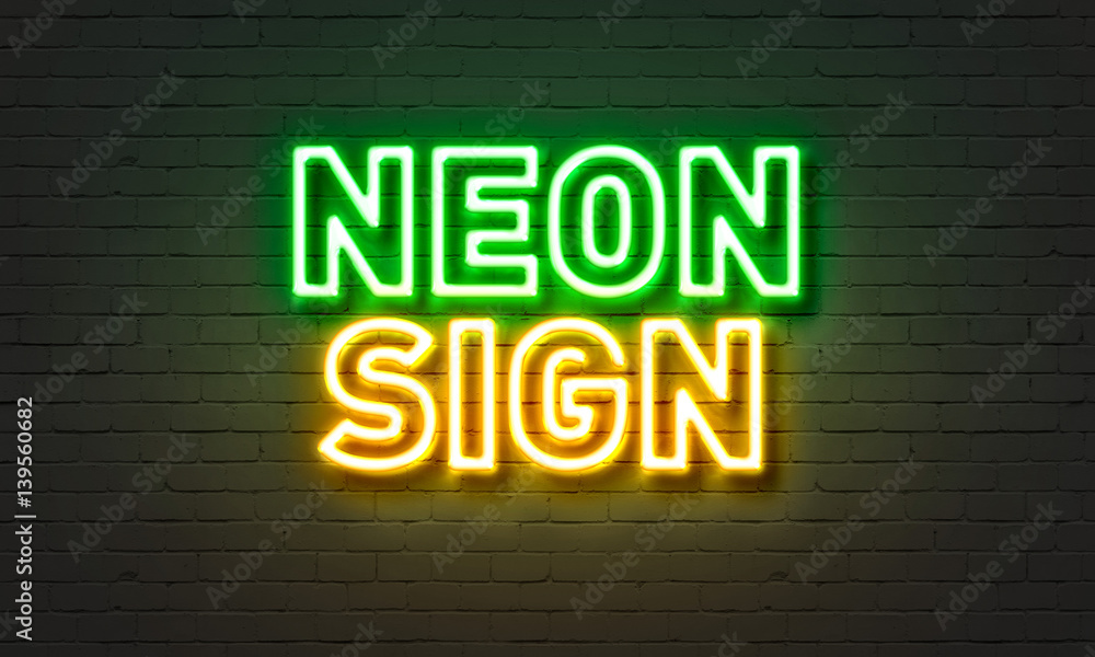 Neon sign on brick wall background.