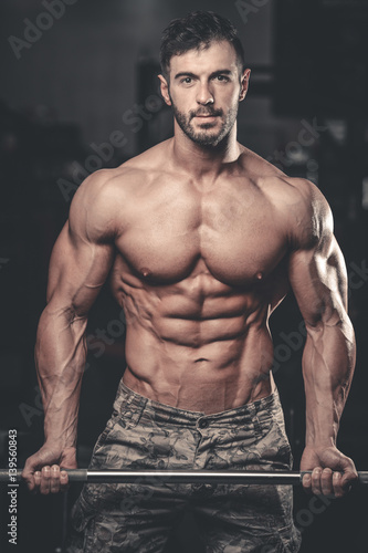 Caucasian sexy fitness model in gym close up abs. © antondotsenko