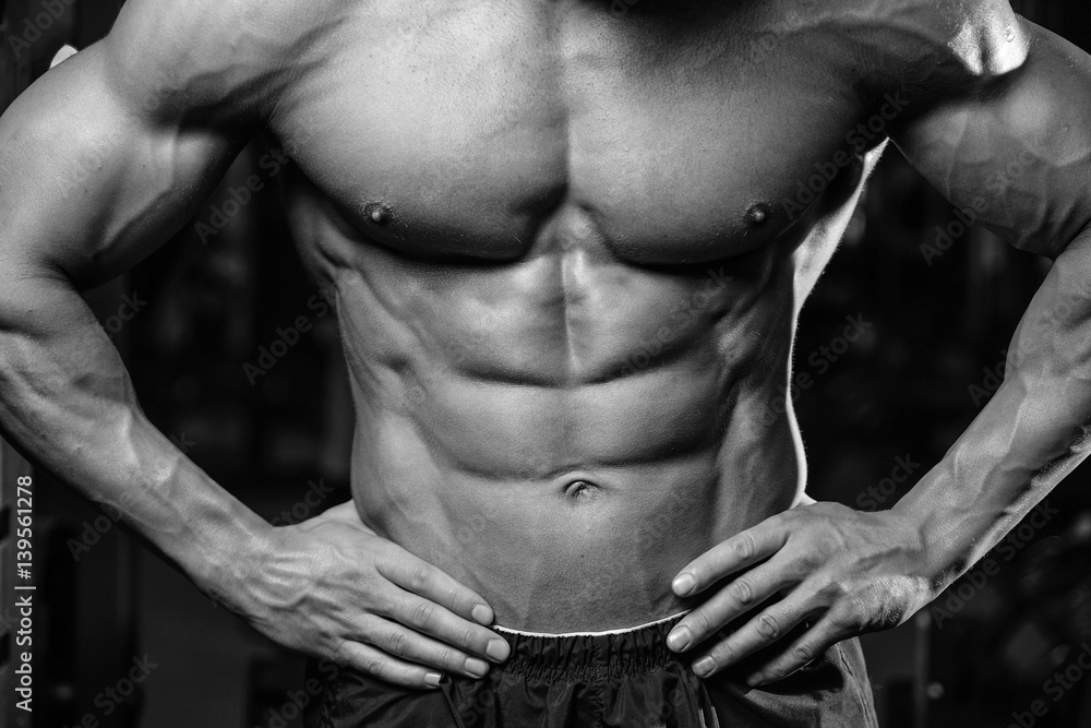Caucasian sexy fitness model in gym close up abs. Caucasian sexy fitness model in gym close up abs.