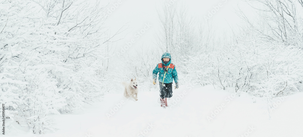 Boy with dog walking in winter
