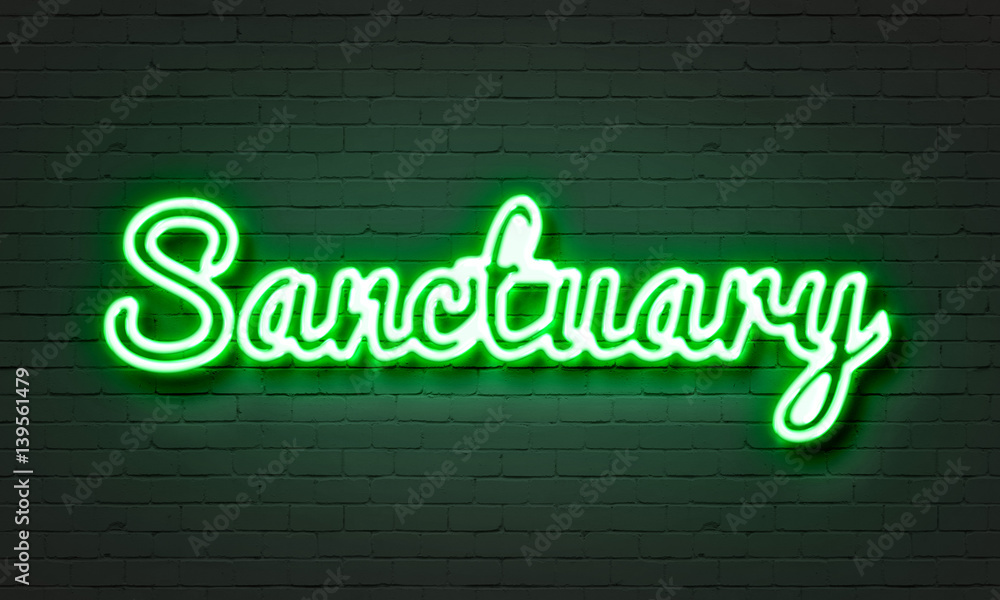 Sanctuary neon sign on brick wall background.