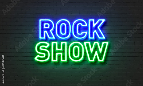Rock show neon sign on brick wall background.