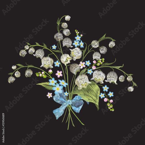 Embroidery colorful floral pattern with lilies of the valley and forget me not flowers. Vector traditional folk fashion ornament on black background.