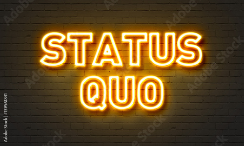 Status quo neon sign on brick wall background. photo