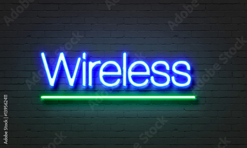 Wireless neon sign on brick wall background.