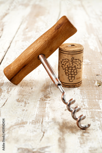 corkscrew with cork on aged wood