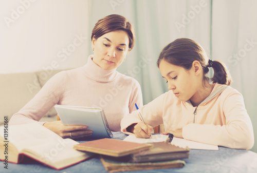 Mother and daughter doing school homework