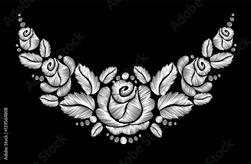 White roses embroidery on black background.