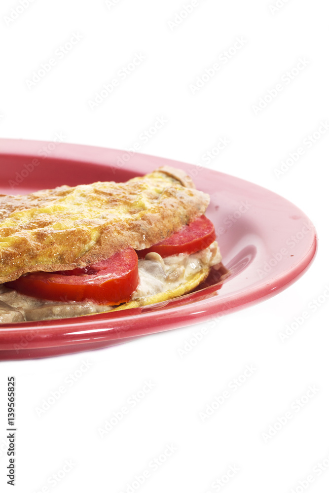 Omelet on a colored plate over white background